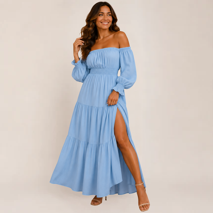 Woman wearing a lightweight tiered midi dress on a plain background.