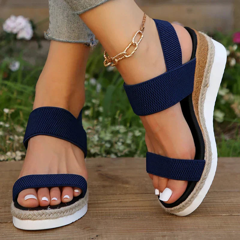Lightweight cushioned sandals shown on a plain background with refined straps.