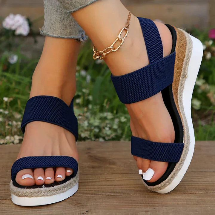 Lightweight cushioned sandals shown on a plain background with refined straps.