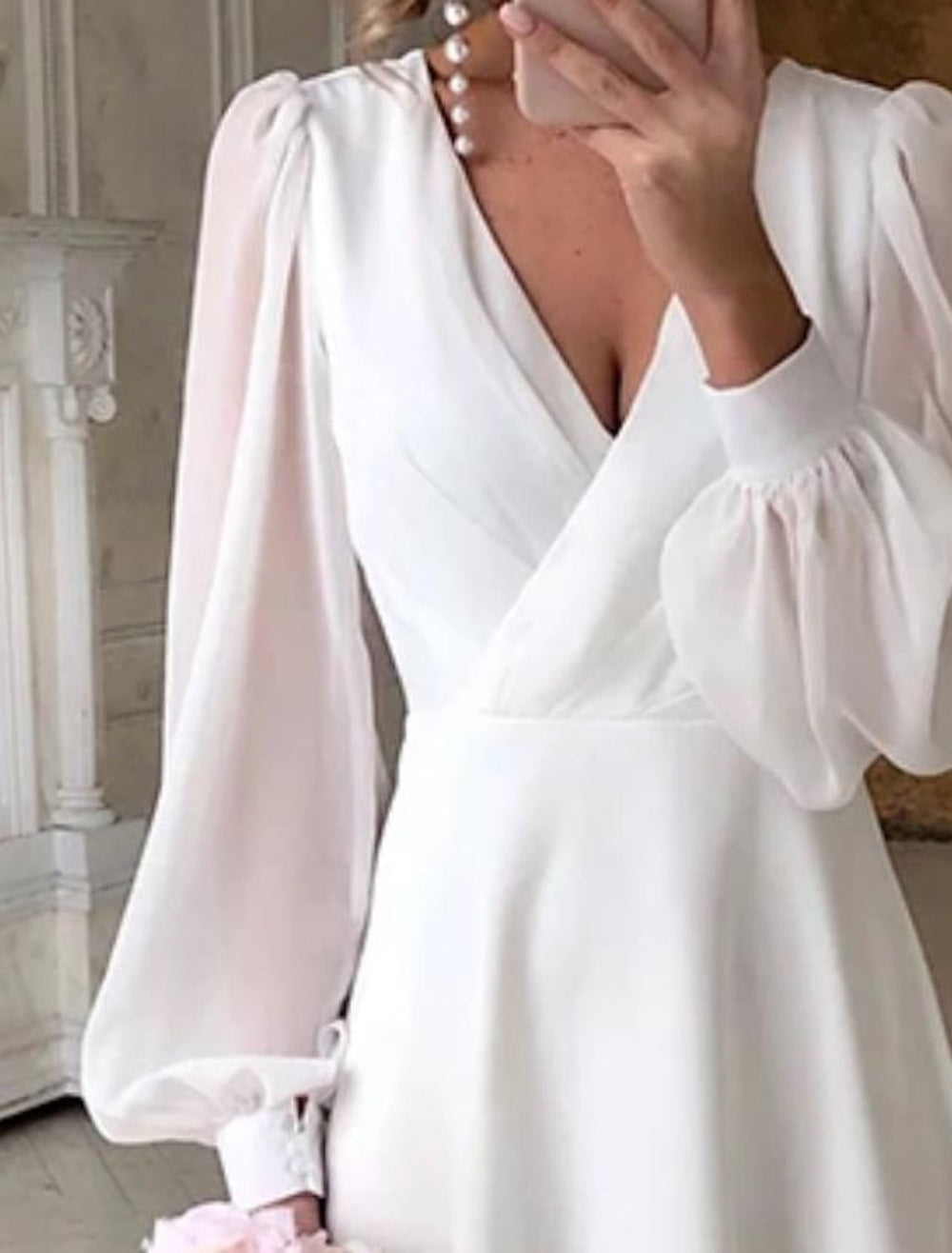 Female model in elegant long sleeve gown facing front gray.