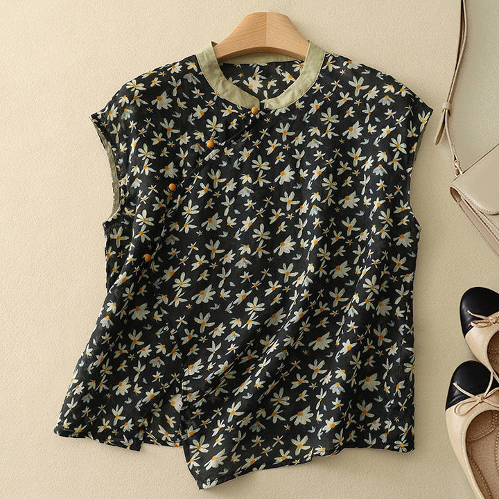 Elegant sleeveless blouse shown on a plain background with refined neckline accents.