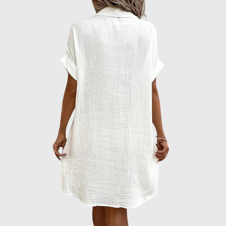  Female model showcasing an elegant relaxed dress with gentle movement.