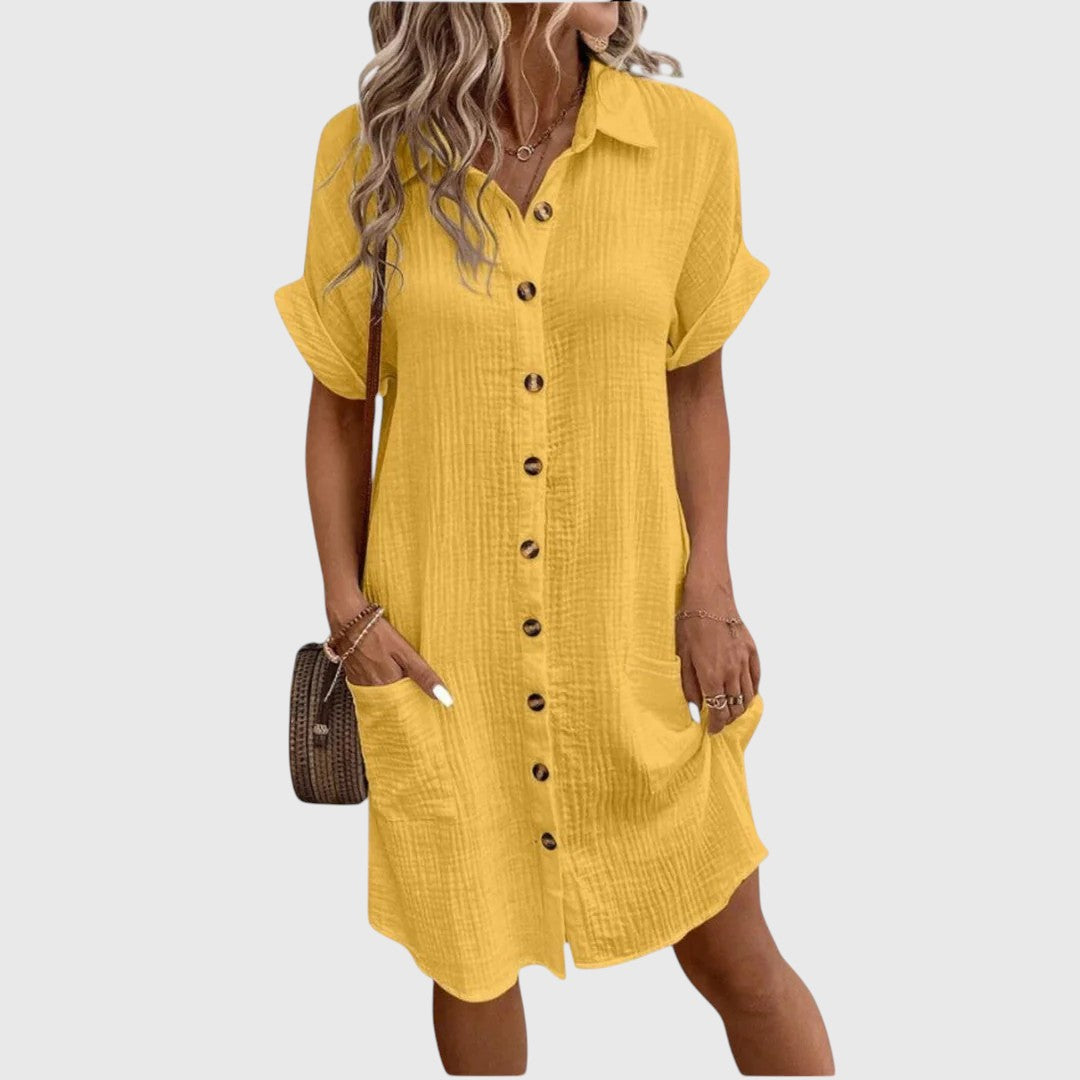 Female model wearing a light flowing dress with a polished finish.