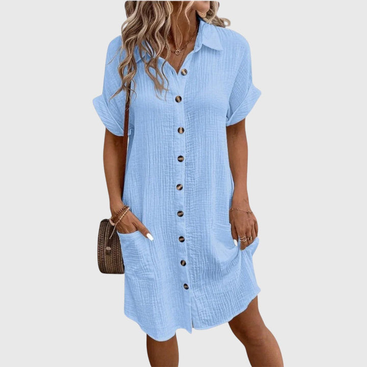  Female model in a graceful dress designed for warm-day styling.