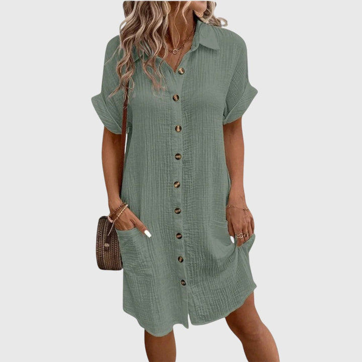  Woman wearing a flowing dress with a refined everyday look.