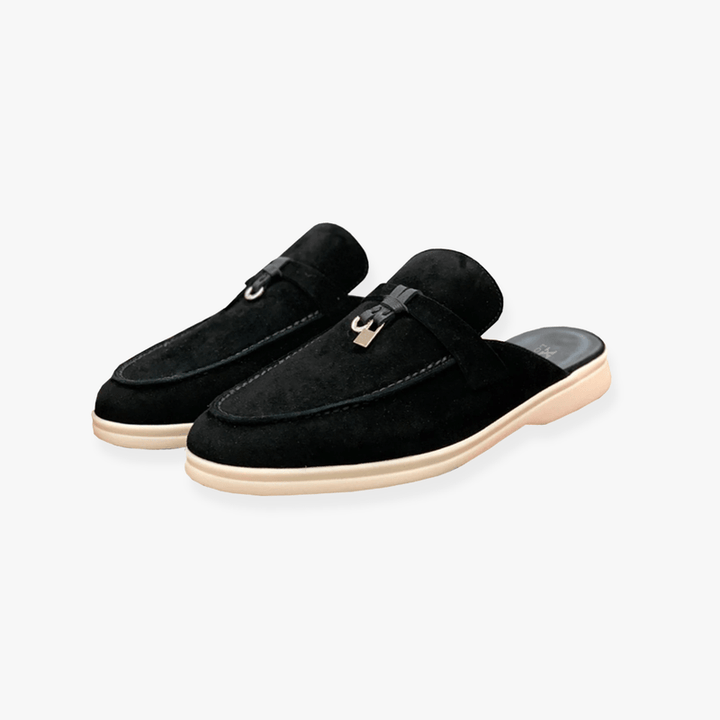 Female model in slip-on mule footwear on a plain background for casual styling.