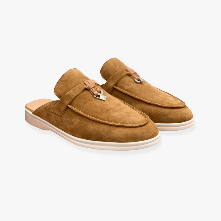 Female model showcasing casual mule shoes on a plain background with a low-profile shape.