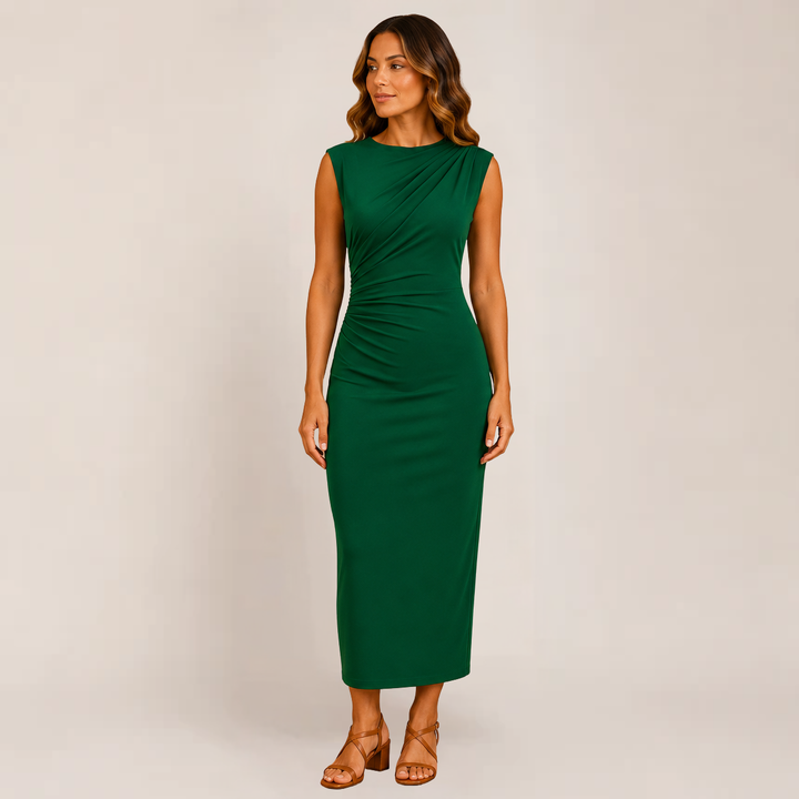 Female model showing a sleek silhouette dress on a plain background.