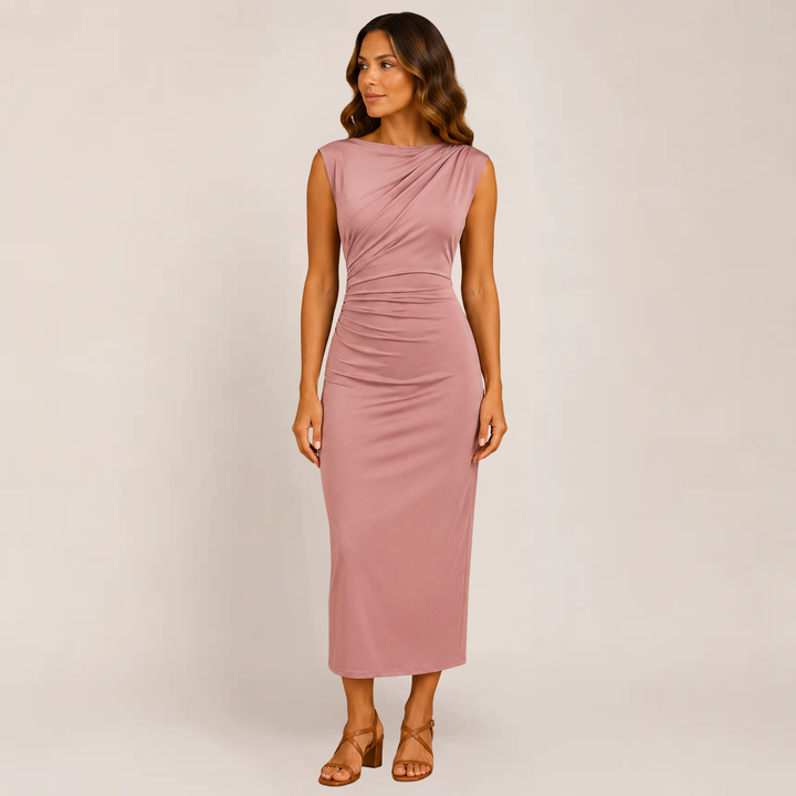 Woman in a sleek dress with clean lines on a plain background.
