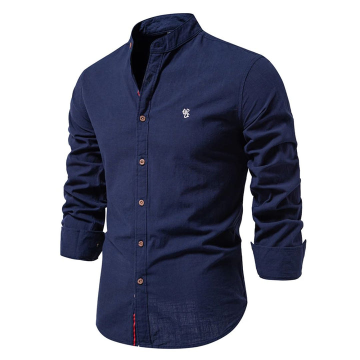 A long sleeve button-up shirt with a stand collar against a plain background.