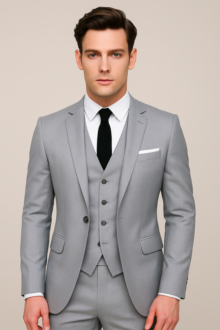 Male model styled in a jacket, vest, and trousers set on a plain background.