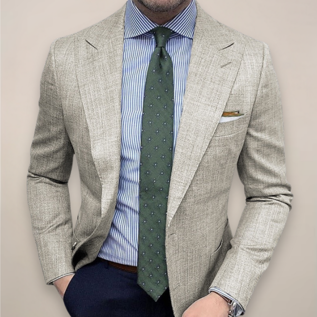 Male model wearing a textured tailored blazer jacket against a plain background.