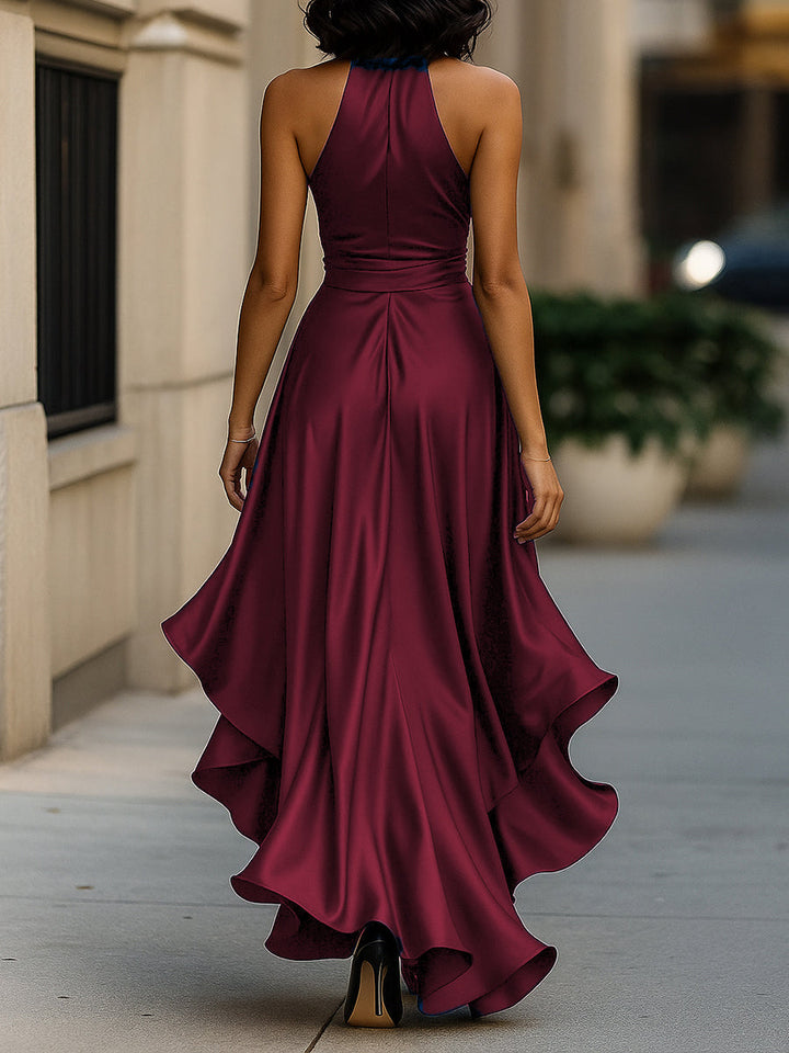 Female model wearing a dressy navy halter gown on a plain background.