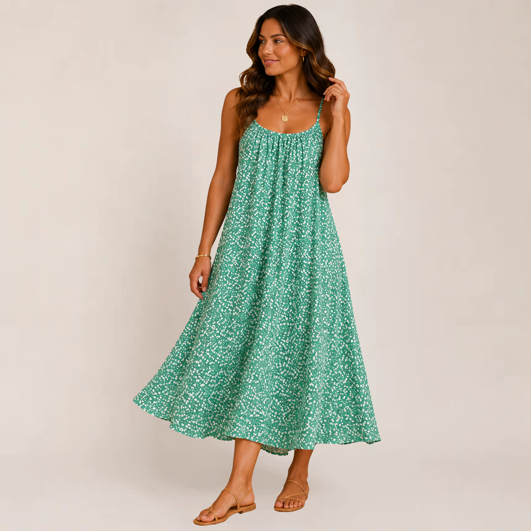 Woman in a breezy floral sundress with soft movement and a relaxed silhouette on a plain background.