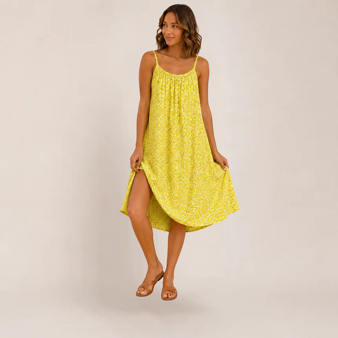 Woman wearing a relaxed floral sundress with a soft feminine shape on a plain background.