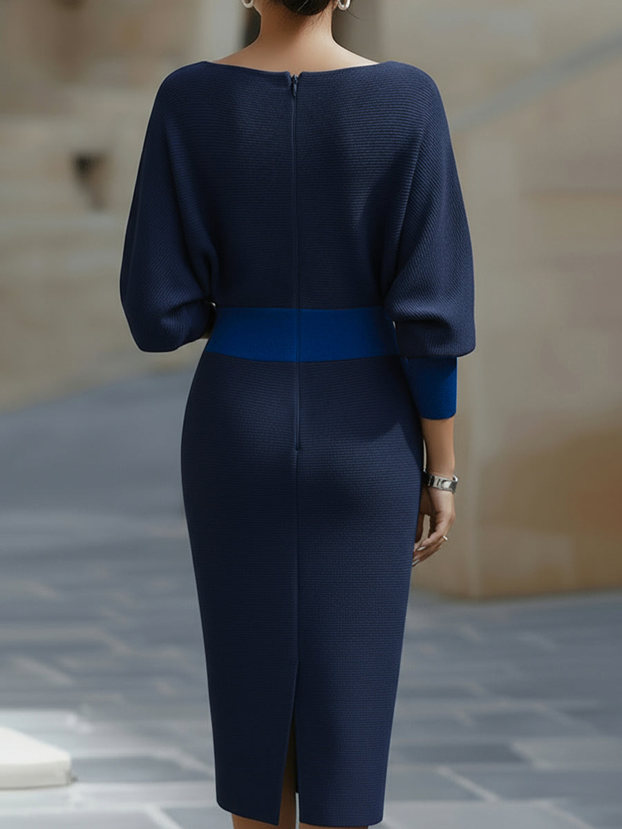Model wearing a white cowl neckline dress with batwing sleeves on a plain background.