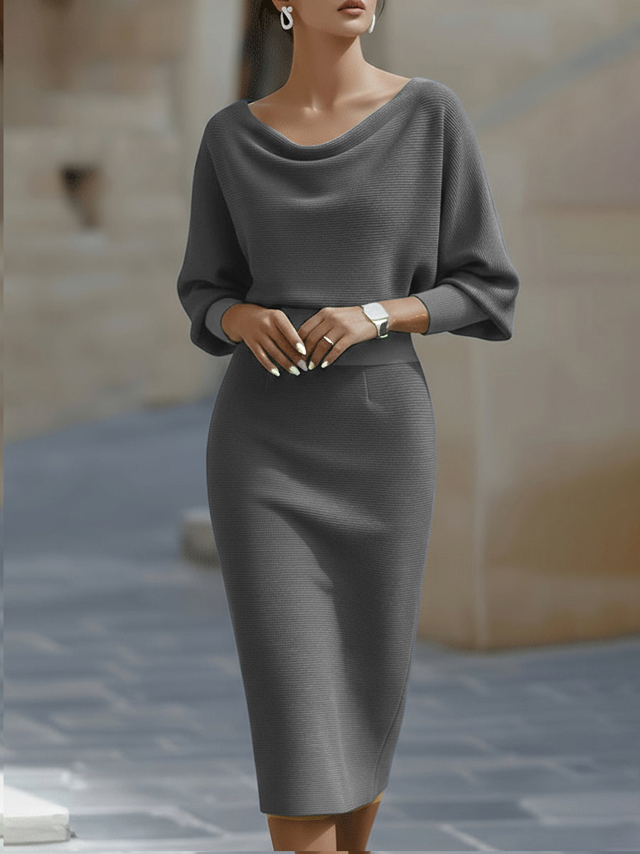 Female model in a white midi pencil dress with draped bodice on a plain background.
