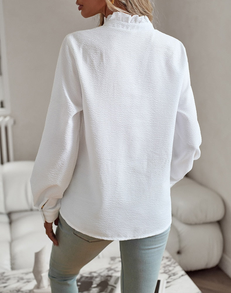 Soft drape top with sleeve detail displayed on a model against a clean background, back view