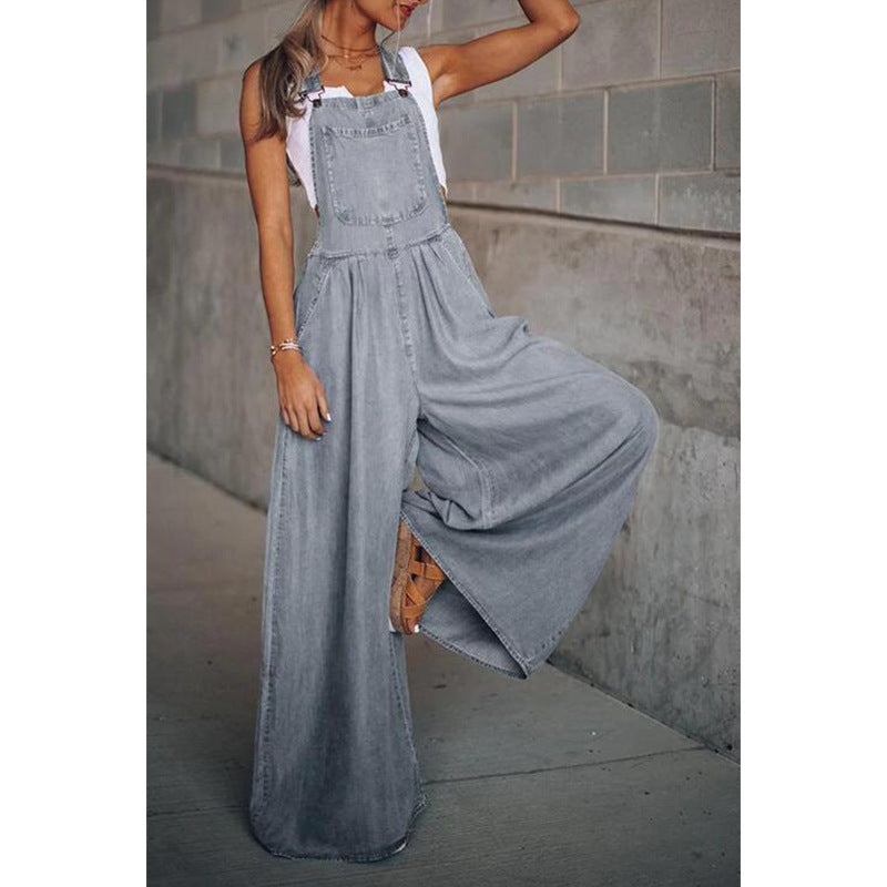 Denim dungaree jumpsuit with button bib front and loose fit.