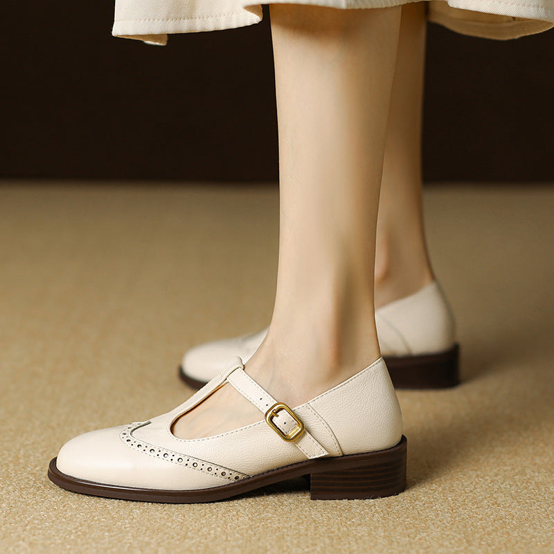 Female model wearing woven flat mules with a square toe on a plain background.
