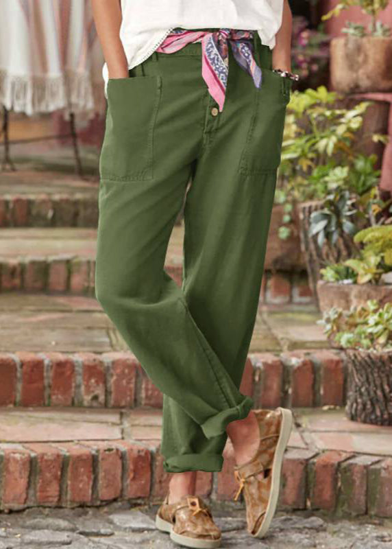 Female model styling relaxed drape trousers on a staircase background.