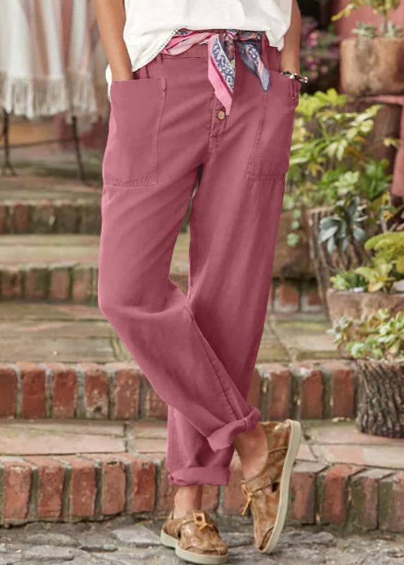 Female model wearing polished relaxed pants on a staircase background.