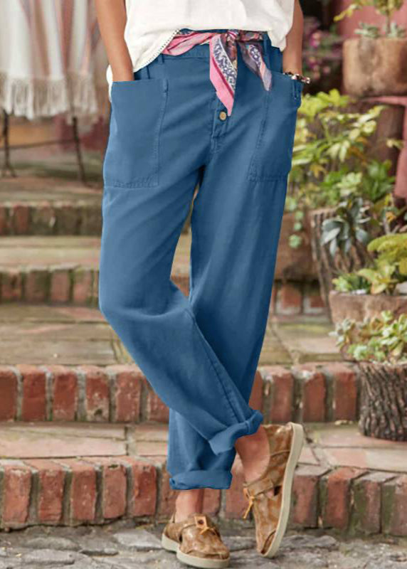 Model showcasing chic wide leg trousers with a staircase background.