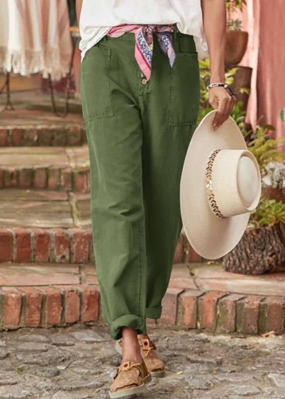 Female model in refined flowy trousers on staircase background.