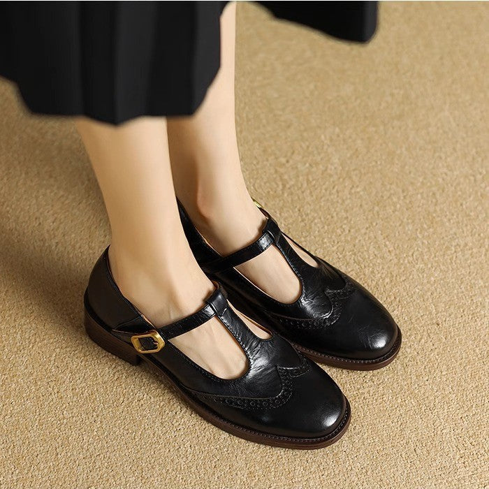Female model wearing square toe woven mules on a plain background.