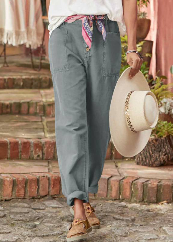 Model wearing graceful drape trousers near a staircase background.