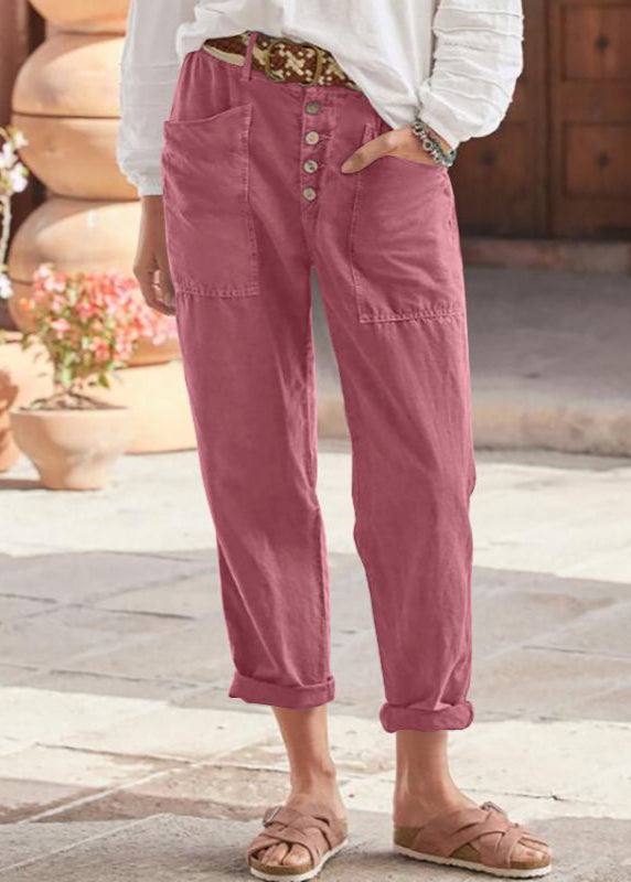 Female model wearing elegant relaxed trousers on a plain background.