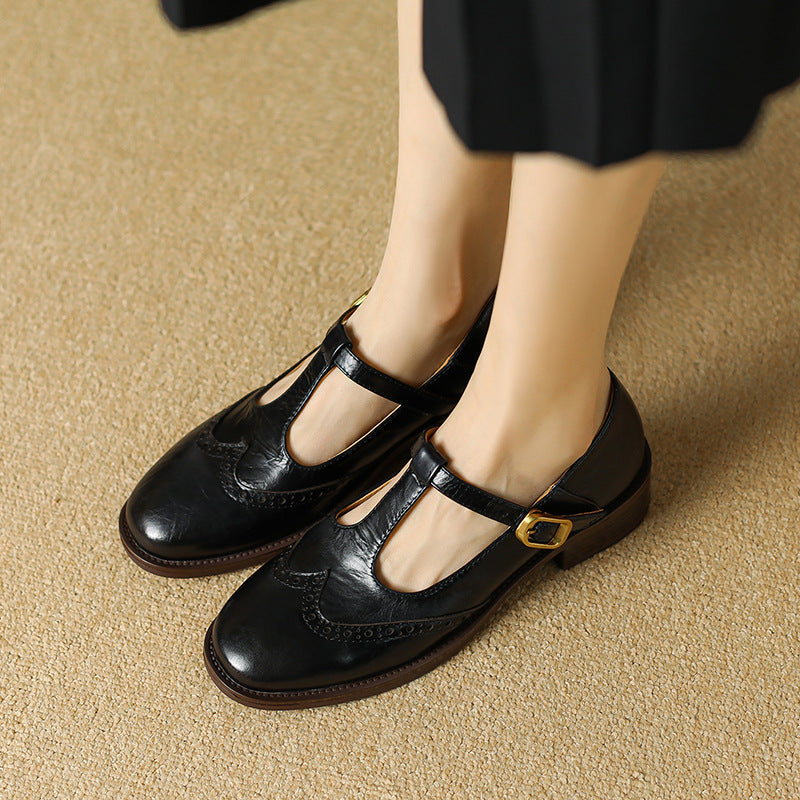 Female model showing woven mule flats with a clean square toe on a plain background.
