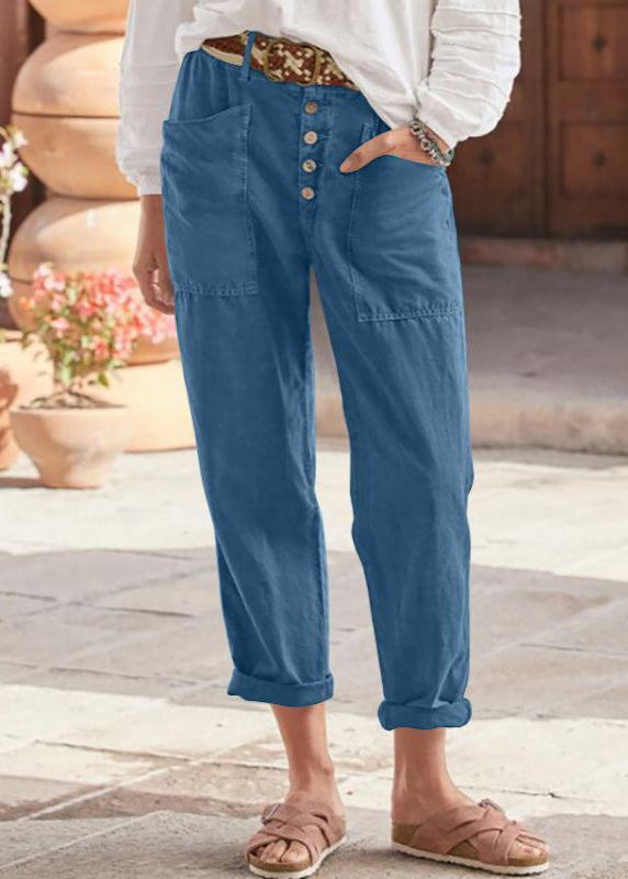 Female model styling versatile relaxed trousers on staircase background.