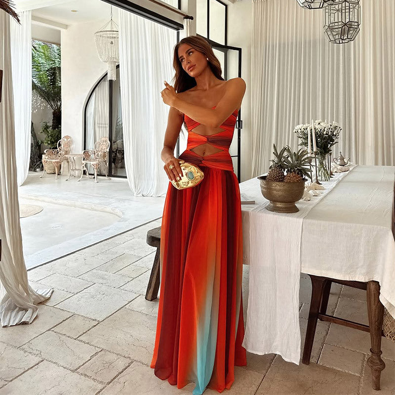 Woman in a flowing tie-dye maxi dress with a Dinning room party background.