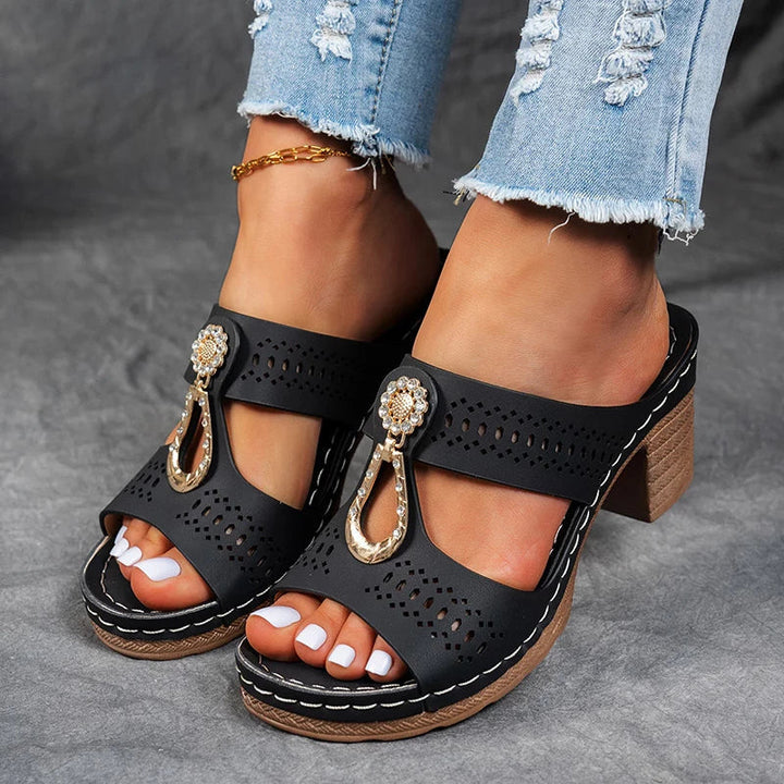 Slip-on wedge sandal with open design and supportive sole on a clean background.