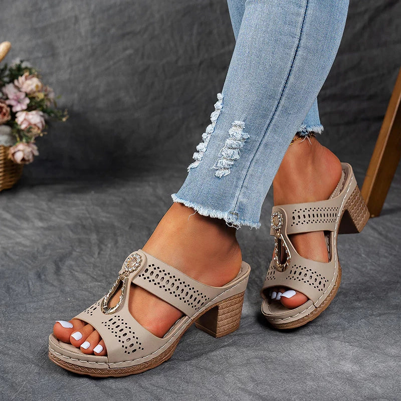 Foot displayed in a stable wedge sandal with modern open accents.