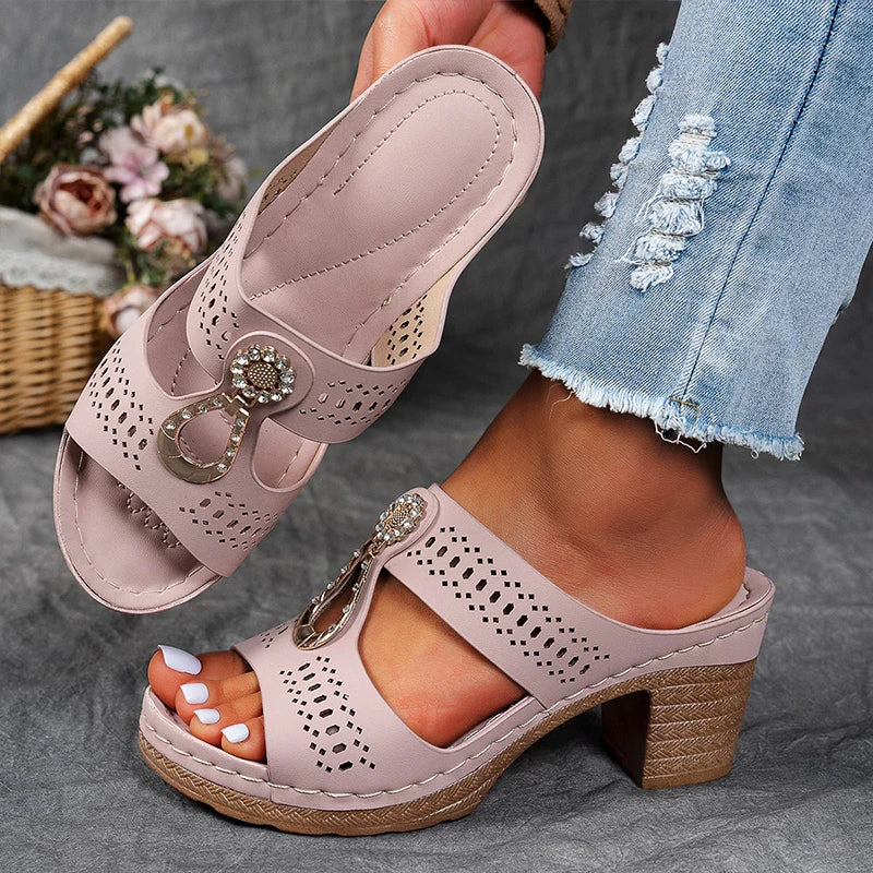 Foot wearing a lightweight slip-on sandal with decorative front detail.