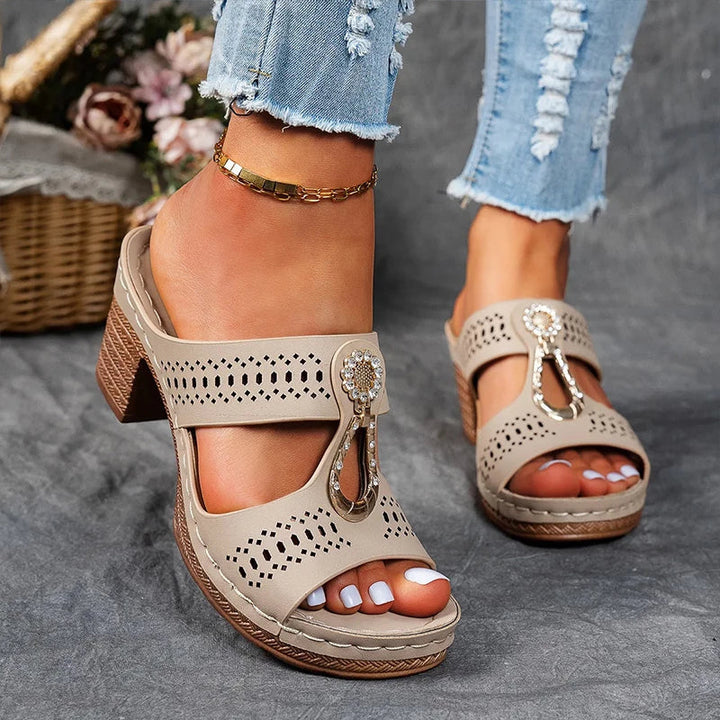 Everyday wedge sandal featuring breathable cutouts and a stable low heel.
