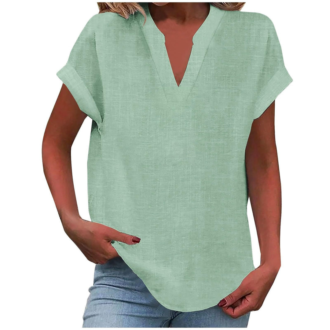 Breathable blouse presented against a plain background with a graceful relaxed silhouette.