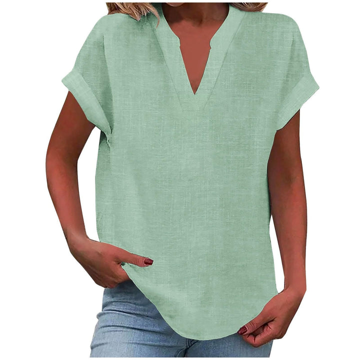 Breathable blouse presented against a plain background with a graceful relaxed silhouette.