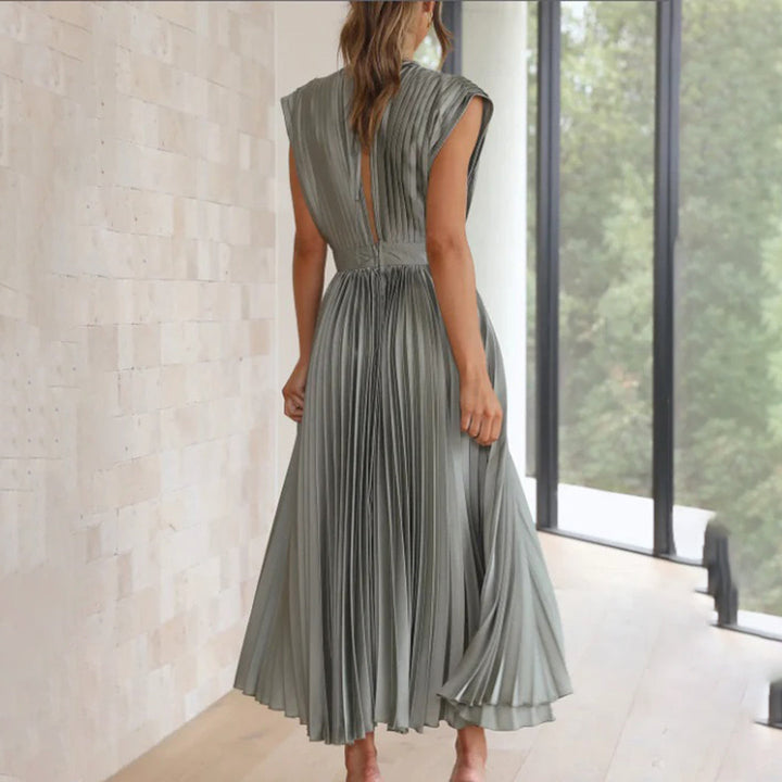 Female model showcasing a timeless dress with a clean background, back view