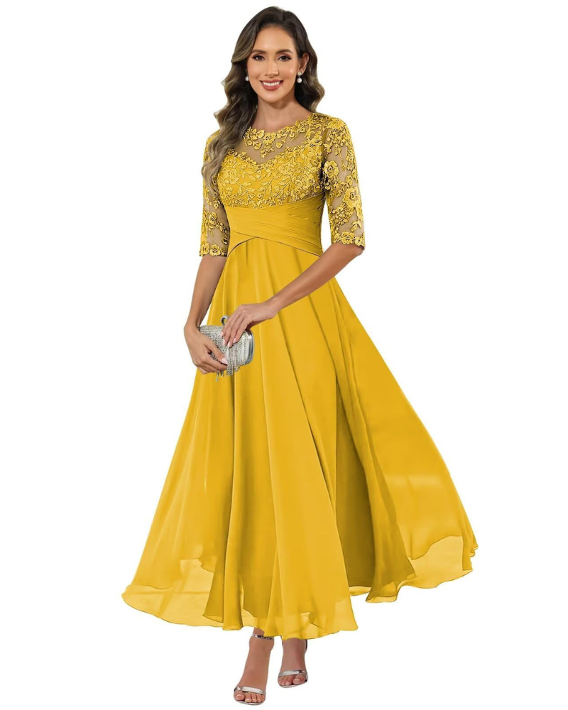 Woman showcasing a graceful long dress on a plain background.