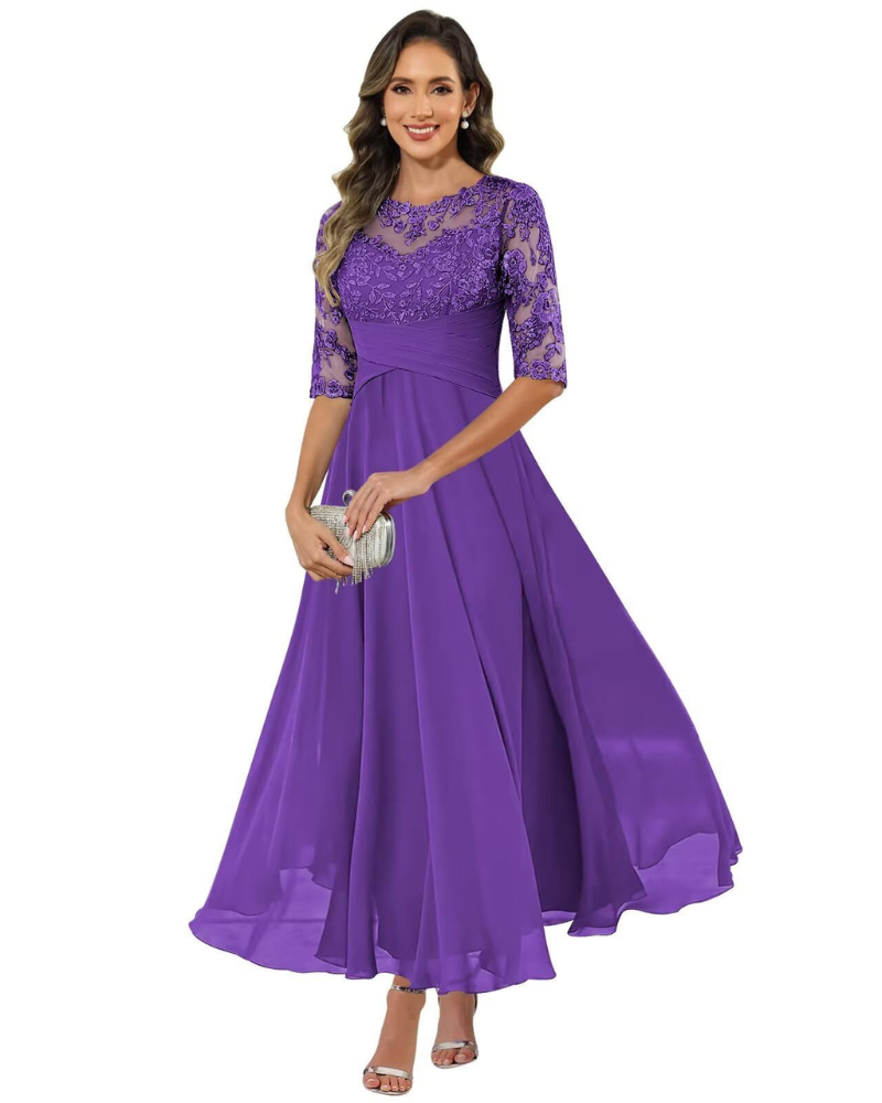 Woman in a long occasion dress shown against a plain background.