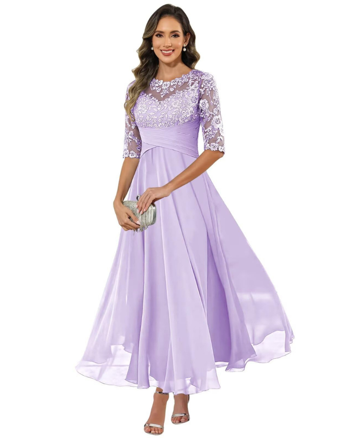 Woman showcasing a refined formal dress on a plain background.