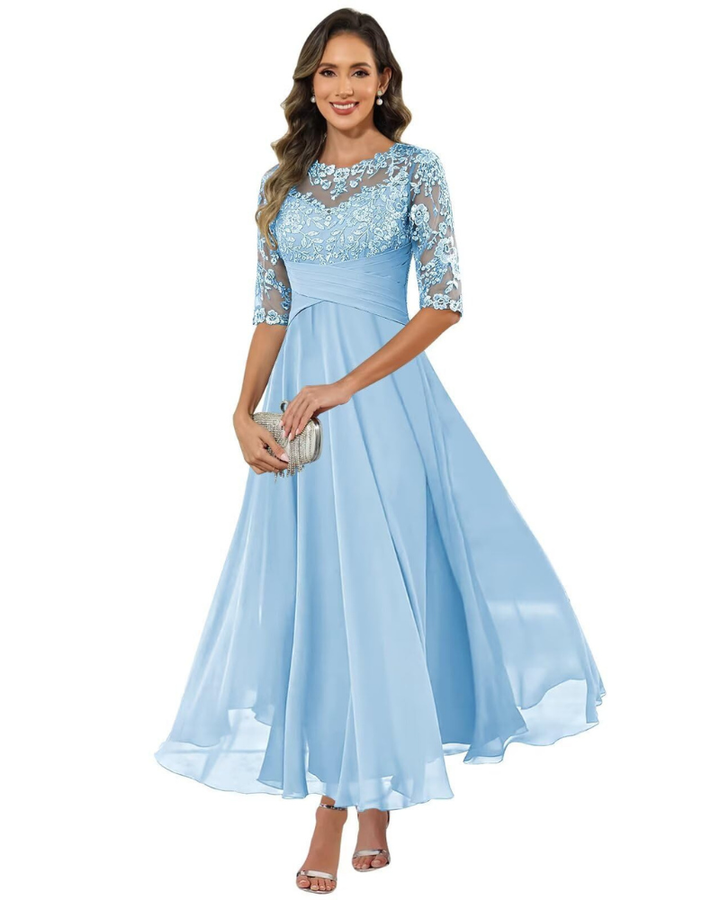 Female model displaying a soft flowing dress with a refined finish.