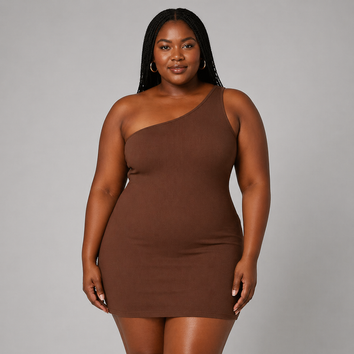 Female model in a sleek one shoulder bodycon dress with a plain backdrop.