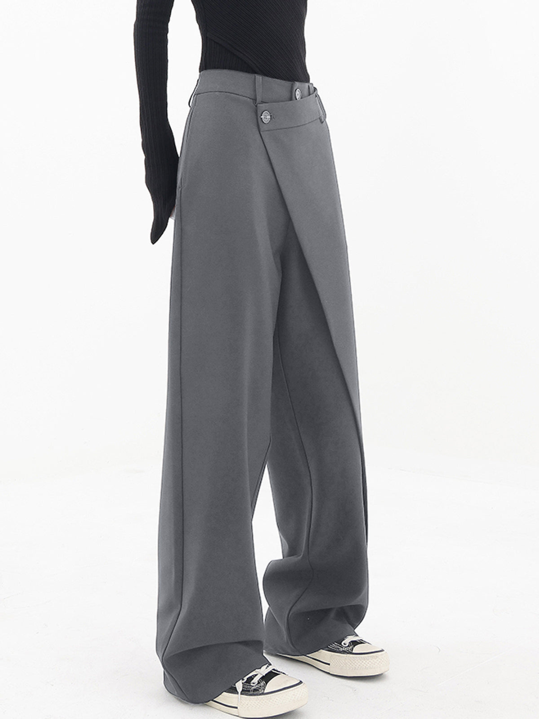 Draped women’s pants with a modern wide leg look on a plain background.