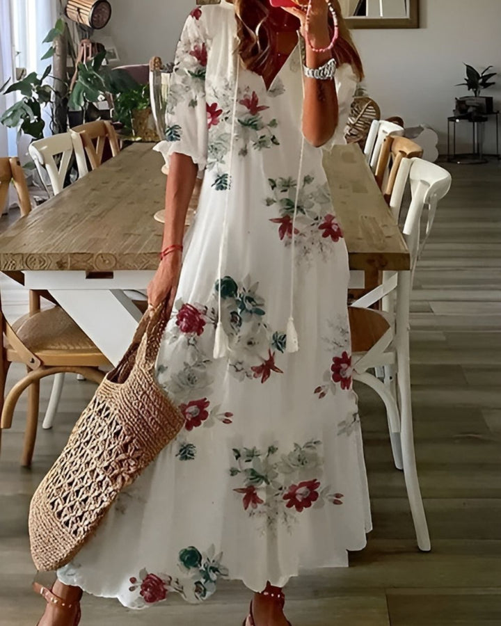 Woman in a relaxed-fit beach-inspired dress photographed on a plain background.