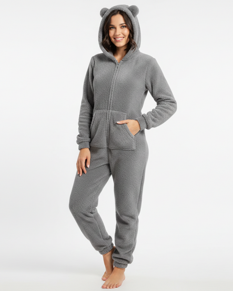  Woman wearing a warm hooded jumpsuit with a casual silhouette against a plain background.