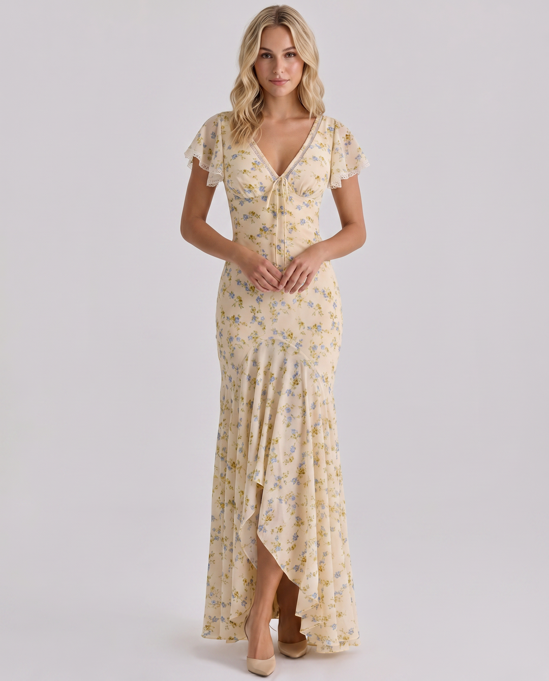 Woman wearing a V-neck floral maxi dress against a plain background.